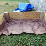 Weed Control Barrier Partially Installed in Raised Garden Box