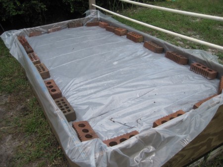 plastic-covered raised garden